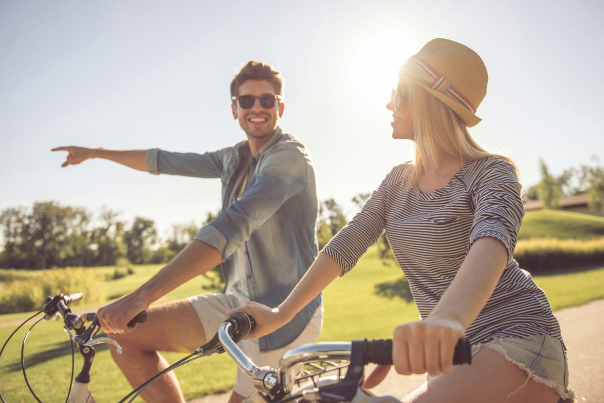 Couple cycling in park Cycling through vineyards: the new way to explore wine regions Exclusive Travel Representation Tourism company representation