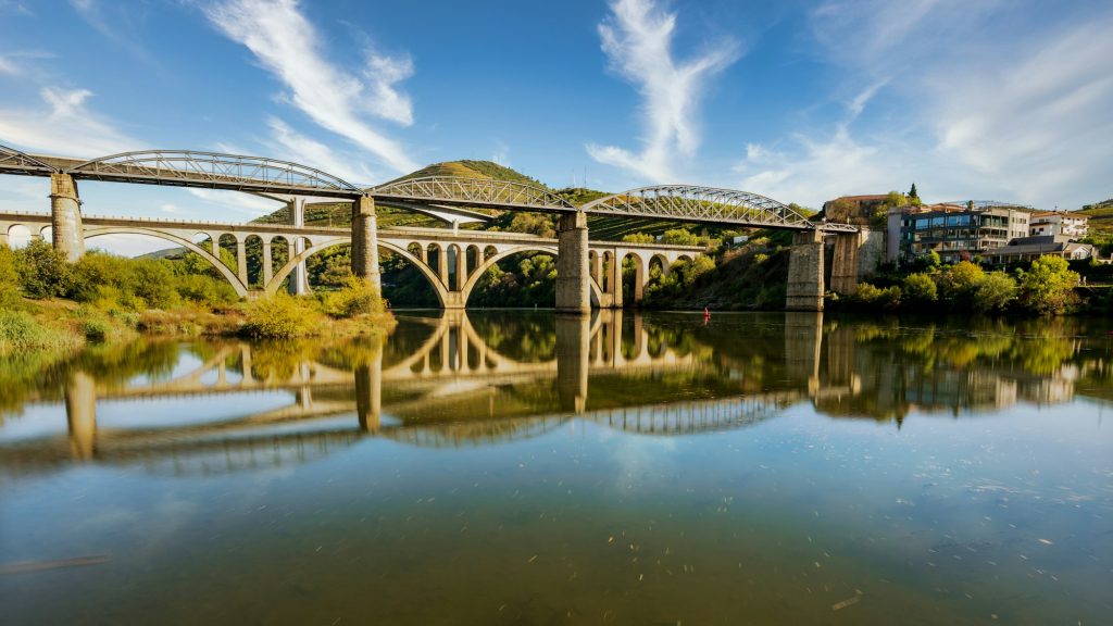 Beautiful shot of bridges in Peso da Regua, Portugal - A Journey throght the best Douro wineries - Exclusive Travel Representation, a luxury travel agency