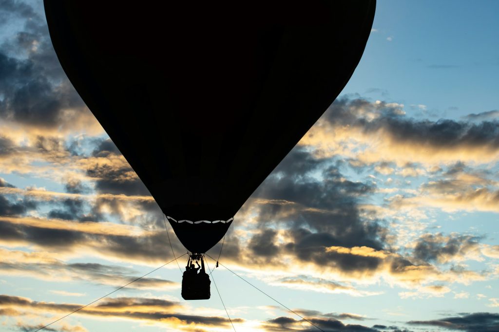 Hot air balloon over blue sky - The Best Aerial Activities You Can Do in Champagne with Champagne Curated Journeys - Exclusive Travel Representation, a luxury travel agency