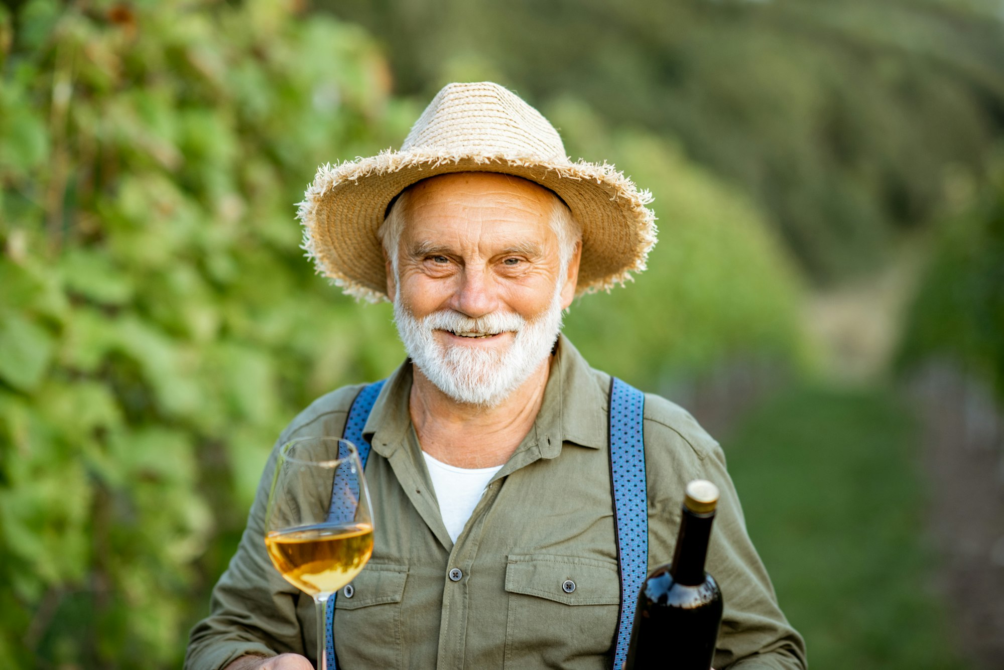 Senior winemaker with wine on the vineyard