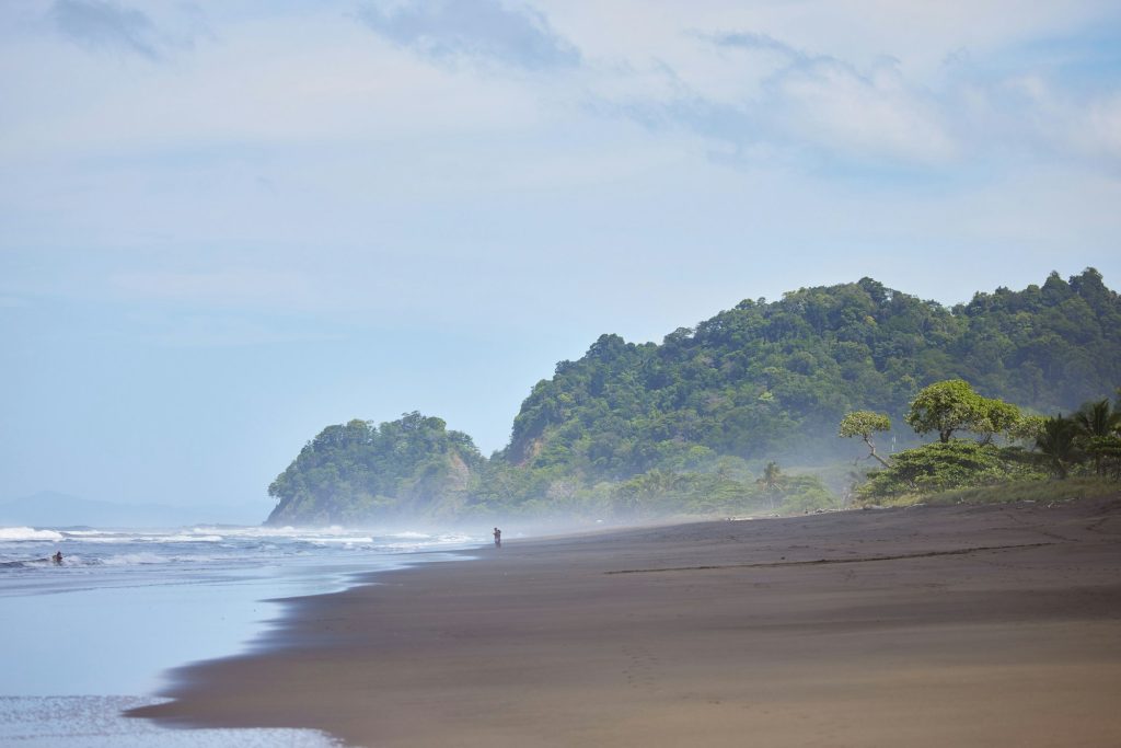 Beautiful Playa Hermosa beach in Costa Rica with lush trees in the background. MagnaPacific Villas exclusive Travel Representation