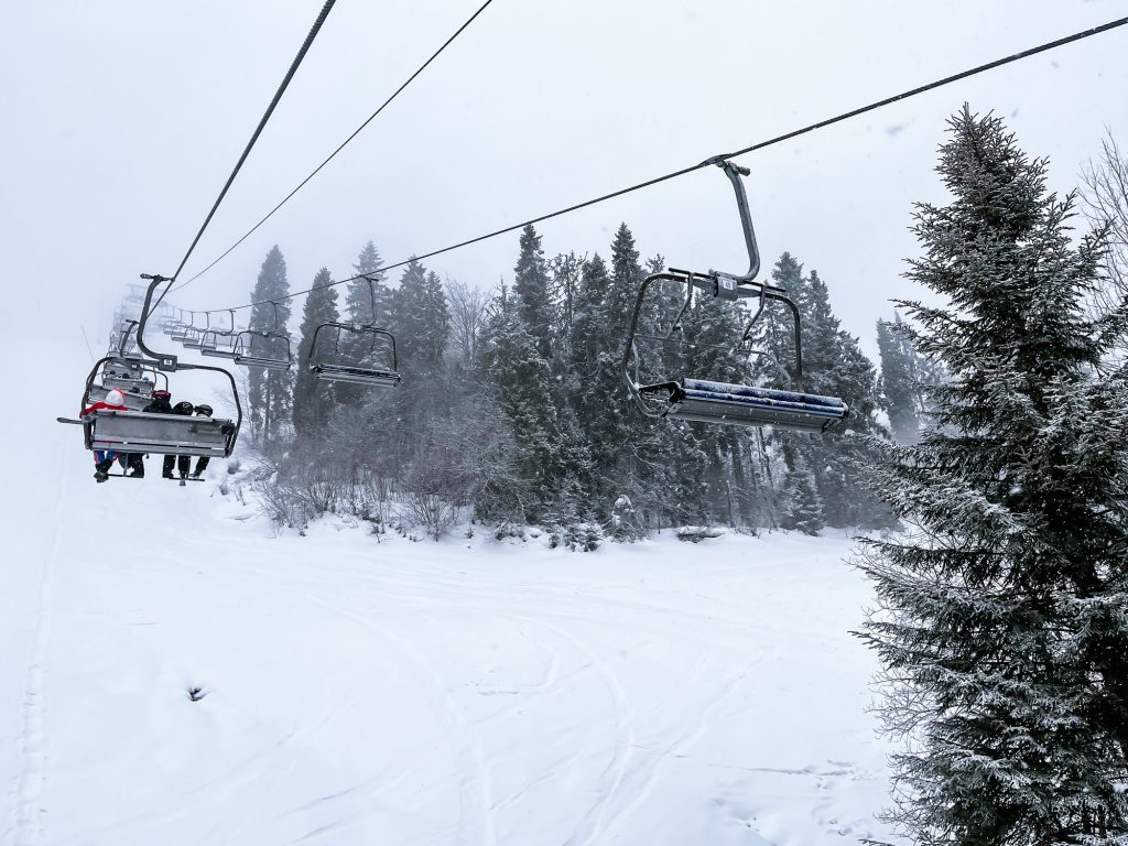 Ski Lift snowy mountain winter forest with chair lift At The Ski Resort in winter. Snowy weather Ski | Experience the winter in luxury villas with exclusive skiing 