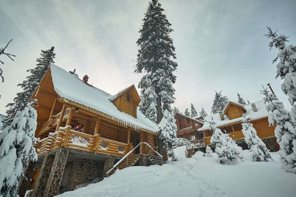 Beautiful chalet in a snowy forest, winter holiday